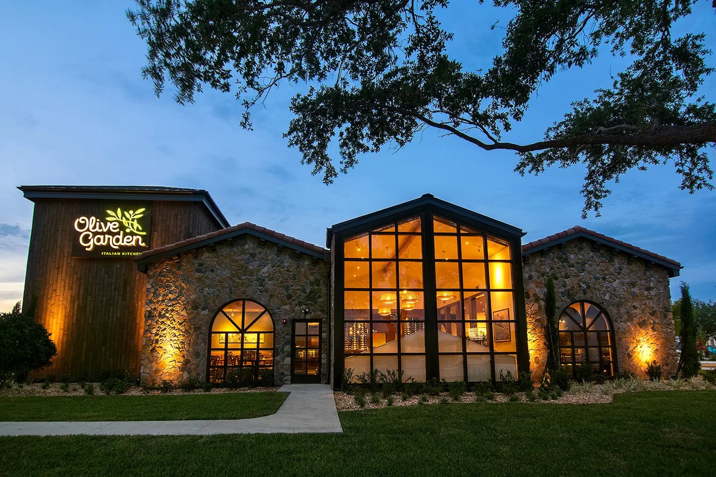Olive Garden restaurant exterior with its illuminated sign at dusk